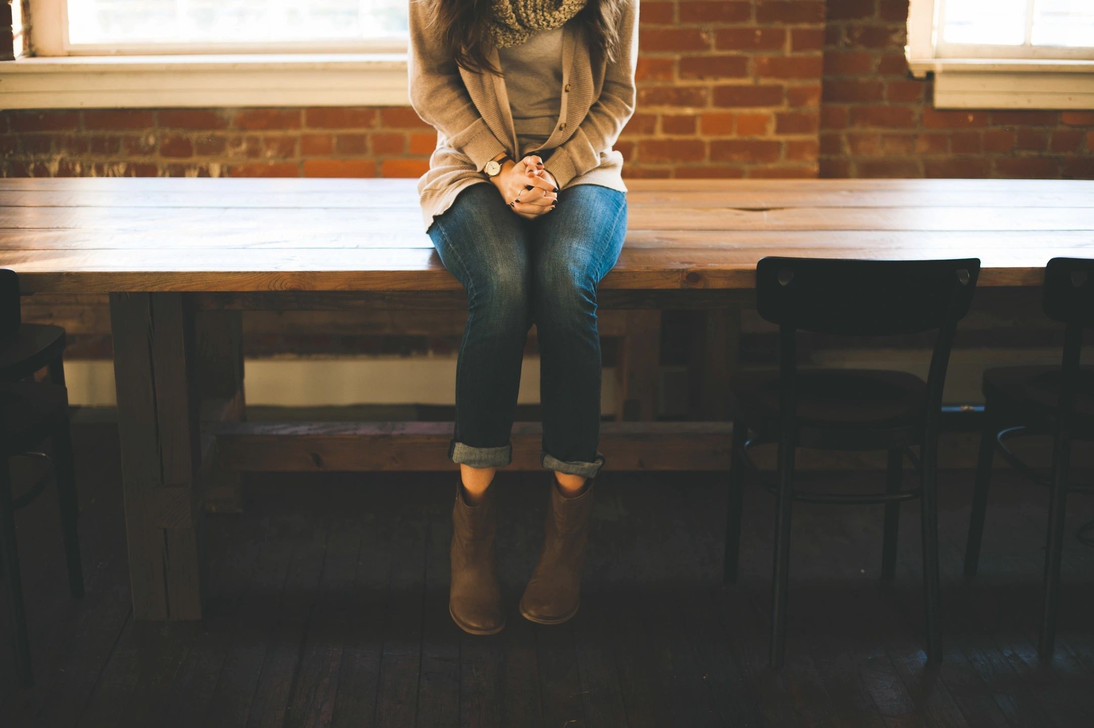 Woman sitting on a bench, photo without face visible