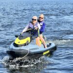 Two older adults in a ski doo