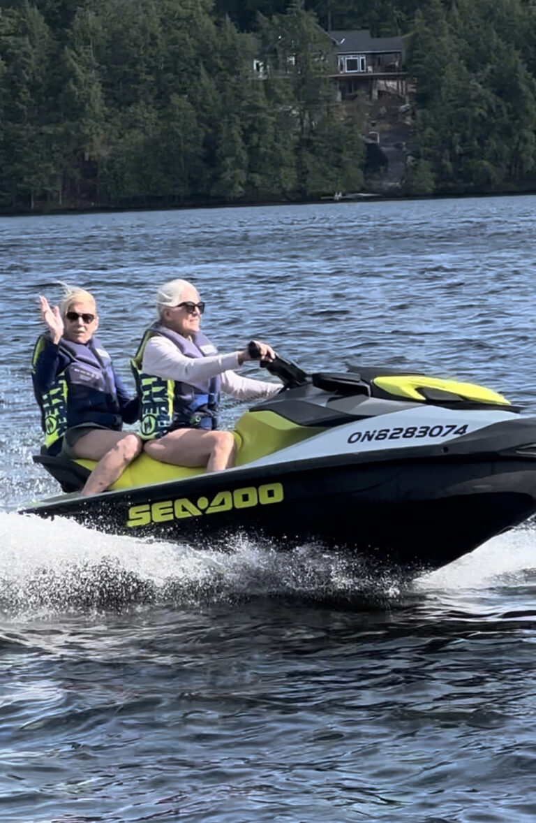 Two older adults on a ski doo